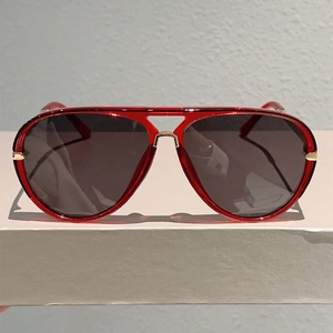 Detailed front view of red transparent aviator sunglasses with gold metal double bridge