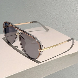 Classic aviator sunglasses with grey acetate frames and gold metal accents on a pedestal