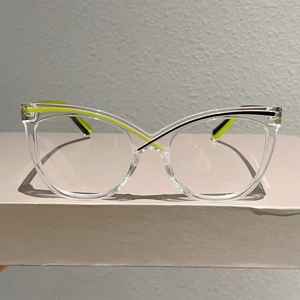 Detail of transparent cat eye frames with fluorescent yellow and black contrast stripes