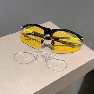 Detail of sports sunglasses with yellow lenses and removable inner frame for myopia
