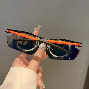 Detail of bright orange temples and dark blue lenses on futuristic sports sunglasses