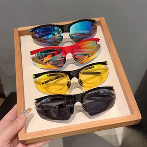 Macro view of four polarized sports sunglasses with different color lenses on a tray