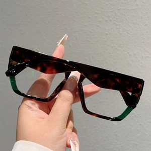 Detail of square oversized frames featuring tortoiseshell and green color-blocking design