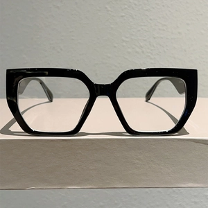 Detail view of bold black square frame glasses showing the premium texture and lens