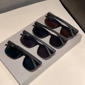 Detailed display of four retro square sunglasses in matte black frames with tinted lenses
