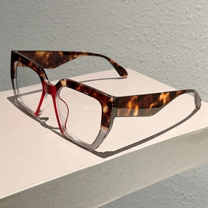 Detail view of square tortoiseshell and transparent frame glasses from a 45-degree angle