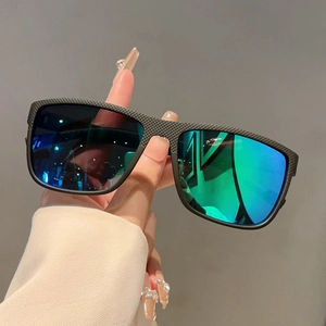 Detail of square vintage sunglasses with black carbon fiber texture and blue gradient lenses