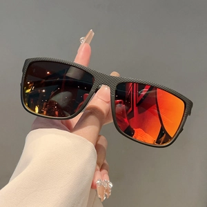 Detail of black textured square sunglasses frame with orange gradient lenses for outdoor use