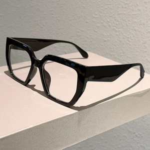 Detail view of bold square black acetate glasses frames with wide temples and retro style