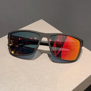 Detail of matte black textured frame with red-orange mirrored lenses on sports sunglasses