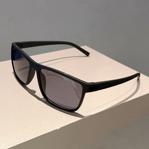 Detail of classic black square sunglasses showing carbon fiber texture on frame