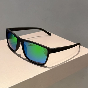 Detail of square sunglasses with black honeycomb texture frame and green gradient lenses