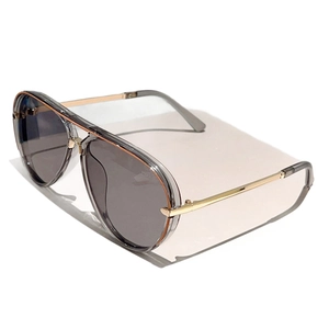Classic aviator sunglasses with gold double bridge and gray lenses on a white pedestal