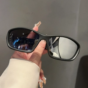 Close-up of matte black sports sunglasses with wide square frames and dark UV lenses