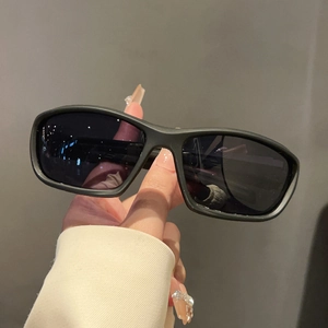 Detail of matte black rectangular sports sunglasses with dark protective lenses
