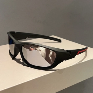 Close-up of matte black sports sunglasses frame with red accents and silver mirrored lenses
