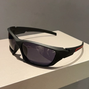 Close-up of black matte sports sunglasses with red racing stripes on a display stand