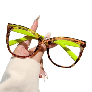Oversized cat-eye glasses frame with tortoise pattern and orange stripe accents
