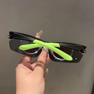 Detail of sports sunglasses with black frames and neon green rubber temple tips