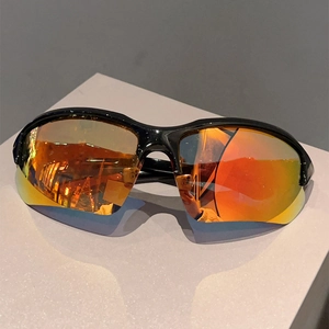 Outdoor sports sunglasses with orange-red mirrored lenses on a white display stand