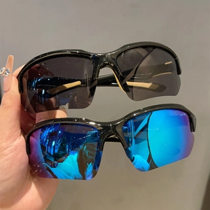 Detail of streamlined sports sunglasses with black and blue reflective polarized lenses