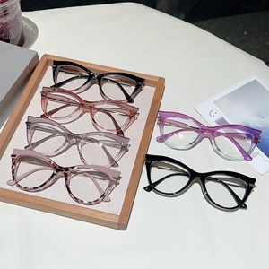 Detailed flat lay of cat eye glasses in multiple colors with metallic hinges