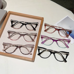 Close-up of cat-eye glasses collection with rhinestone-encrusted rims in varied colors