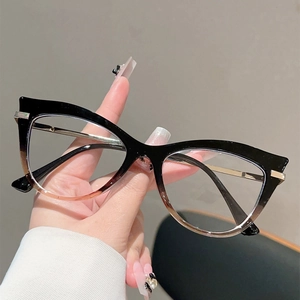 Detailed view of cat eye glasses with black and amber gradient frames and gold temples