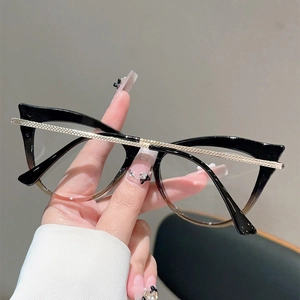 Detailed close-up of cat-eye frames with gradient color and engraved gold metal temples