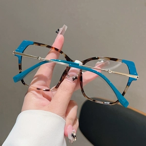 Detail of blue and tortoiseshell cat eye glasses with stylish gold metal accents