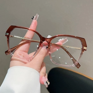 Detail of gradient red-brown cat-eye glasses frame with champagne gold metal temples