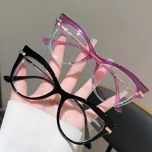 Detail of cat-eye glasses frames in black and purple gradient with gold accents