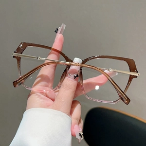 Detail of gradient brown to pink cat-eye frames with slim gold metal temples