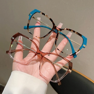 Detail view of cat-eye frames featuring blue-green tortoiseshell and pink gradient finishes