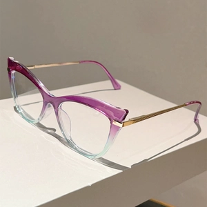 Close-up of cat-eye frames with purple-to-teal gradient and textured gold metal temples