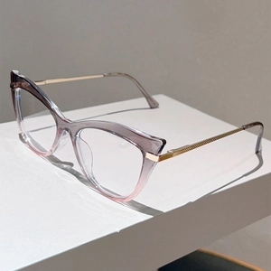 Detail view of cat eye frame with purple gradient transparency and gold metal temples