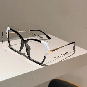Detailed view of oversized cat-eye glasses with black and white color blocking