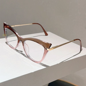 Detailed side view of cat-eye frames with gradient brown to pink finish and gold metal temples