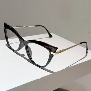 Close-up of cat eye frames with black finish and textured gold metal temples