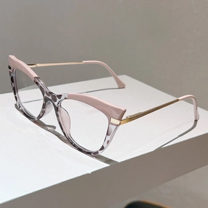 Detail view of pink cat-eye glasses with leopard pattern and gold metal temples