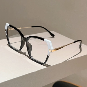 Detail of cat-eye frames featuring black and white contrast and gold metal temples