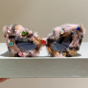 Détail de lunettes de soleil en peluche léopard avec strass colorés et verres gris
