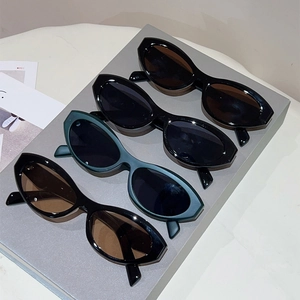 Detailed row of vintage cat eye sunglasses in black and green finishes on display