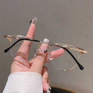 Detailed close-up of slim gold metal eyeglass frames with black anti-slip ear tips