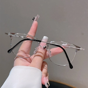 Detail of silver metal frame eyeglasses with minimalist thin temples and clear lenses