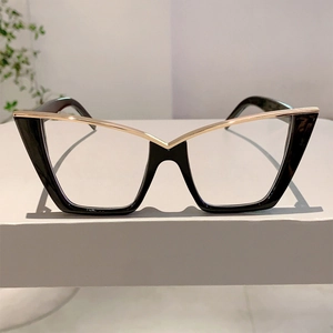 Detailed view of cat-eye glasses with glossy black frame and elegant gold metal bridge
