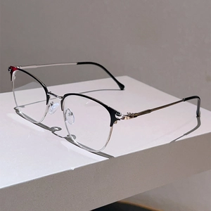 Detail view of stylish browline glasses with black top frame and silver metal accents