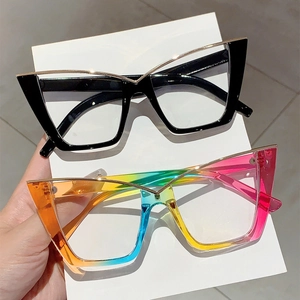 Detail of cat eye glasses showing black and rainbow frames with gold metal accents