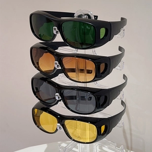 Detailed comparison of cycling goggles in green, amber, grey, and yellow lenses