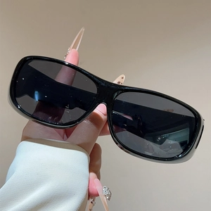 Detail of rectangular black sports sunglasses with wide frame and dark polarized lenses